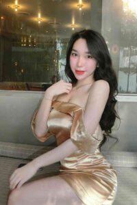 Woman in a gold satin dress