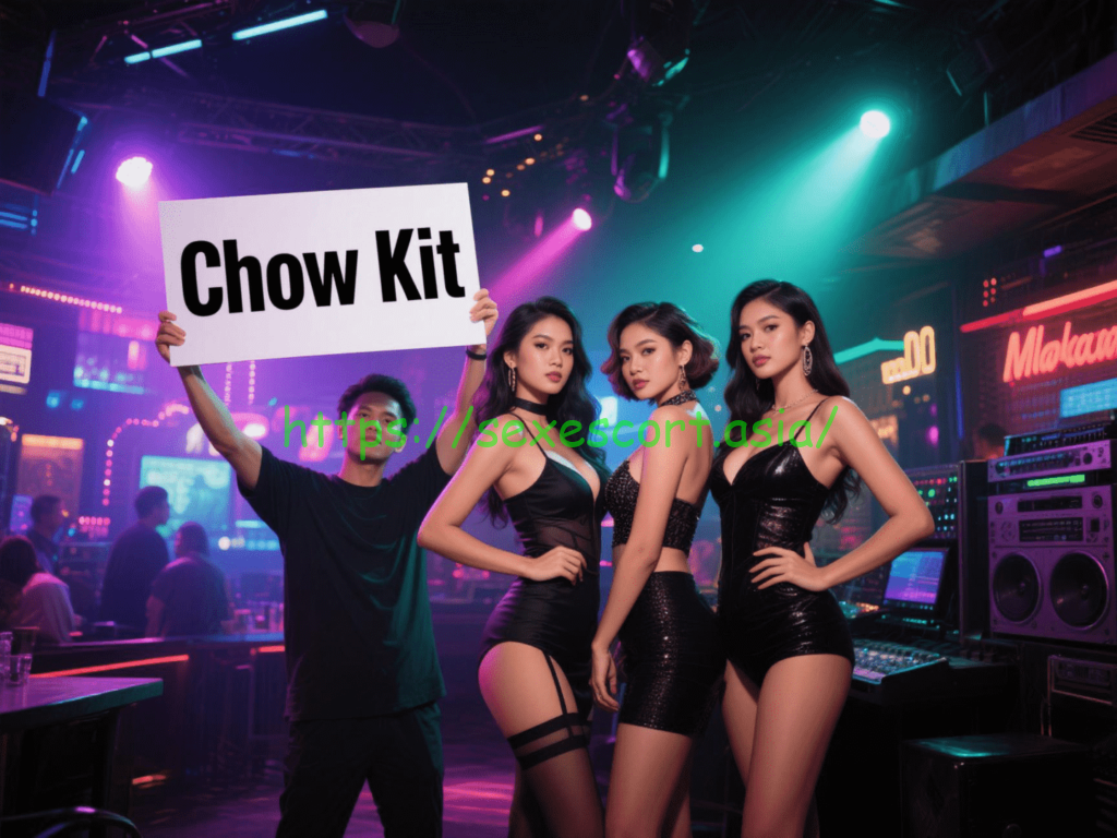 Three women in black outfits at a club hold a sign that says "Chow Kit".